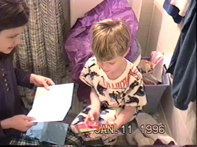 Vintage VHS footage from 1996 shows a young boy getting excited as he opens a Yak Bak 2 toy for his birthday