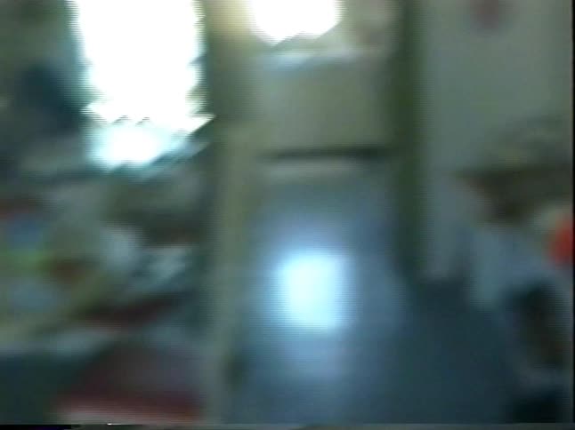 Vintage VHS footage captures a family playing a pizza-themed board game together in their 1990s-style vacation condo