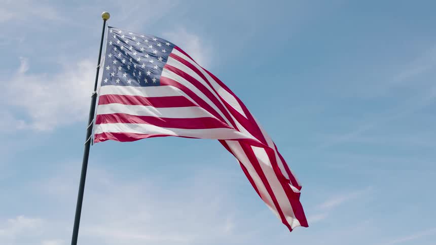 Underslung approach towards the American flag waving gracefully in the wind
