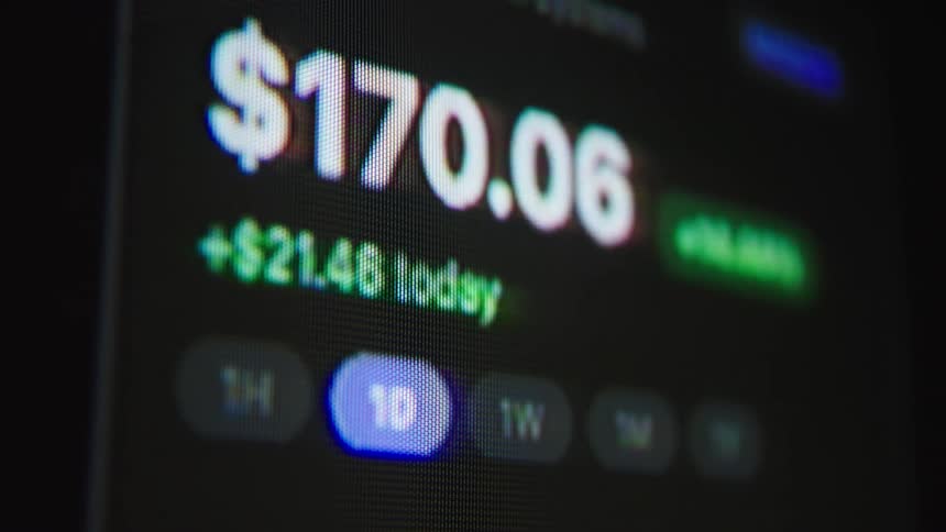 A macro close-up of a digital screen shows stock market or cryptocurrency prices fluctuating in real-time