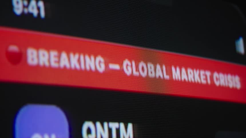 A breaking news alert flashes on a digital screen, announcing a global market crisis