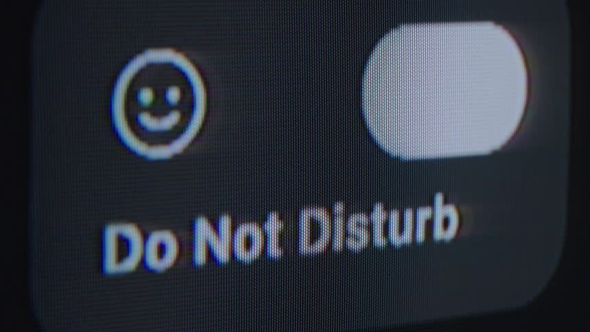 Activating the 'Do Not Disturb' mode on a smartphone screen in an extreme close-up