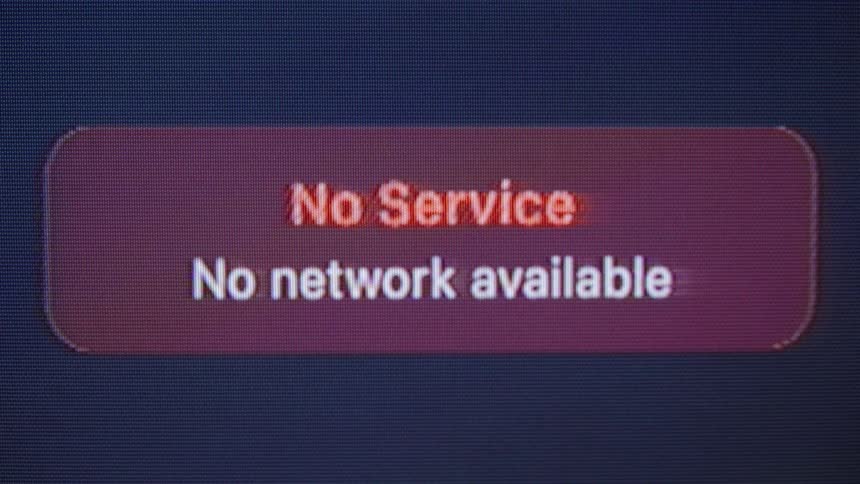 A close-up of a digital screen shows a 'No Service, No network available' error message before turning off
