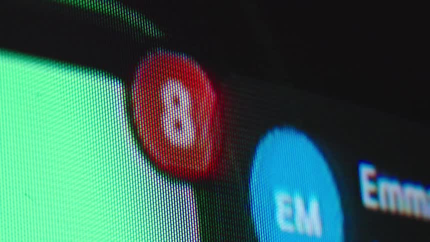 A macro close-up of a digital screen shows a message notification counter rapidly increasing
