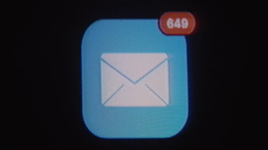 A close-up of a digital email icon on a screen shows the unread message notification count rapidly increasing into the hundreds