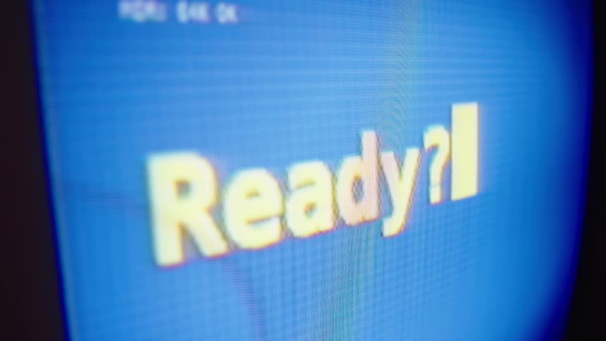 A vintage computer screen with the word 'Ready?' and a blinking cursor flickers and shuts off
