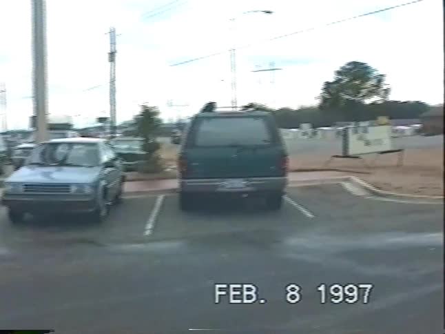 A classic 1997 McDonald's with an outdoor PlayPlace, captured on vintage VHS footage before panning over to a packed family minivan