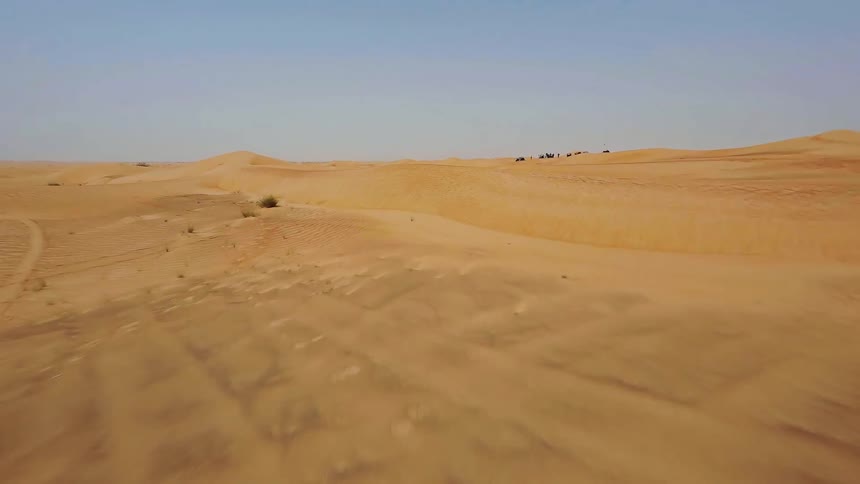 A thrilling first-person aerial view glides over the beautiful, rippling sand dunes of an endless desert
