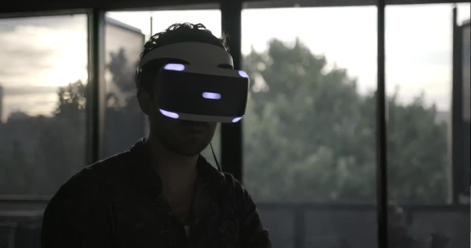 A man looks around using a vr headset and a controller