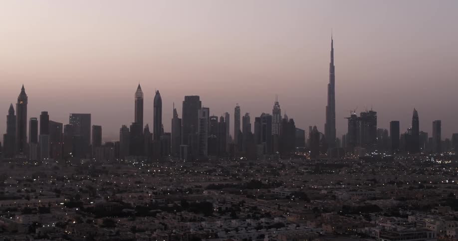 The city is dark at sunset