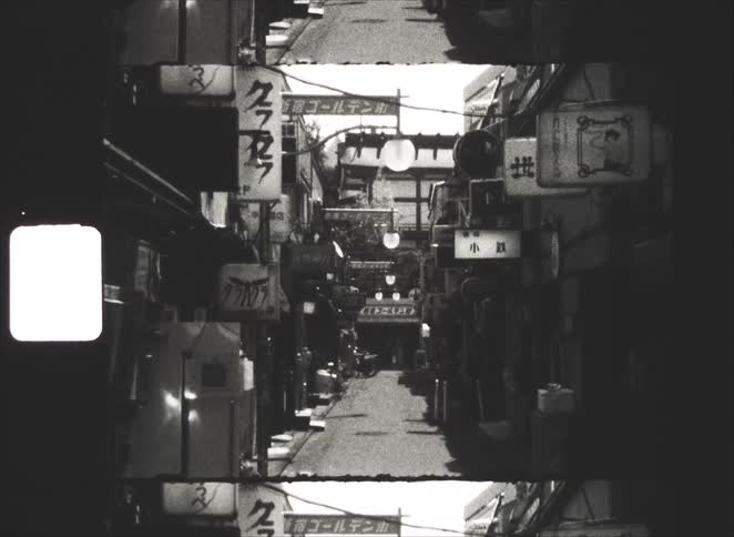 Fragmented black and white vintage footage slowly zooms out of a narrow, sign-filled alley in Shinjuku Golden Gai, Tokyo