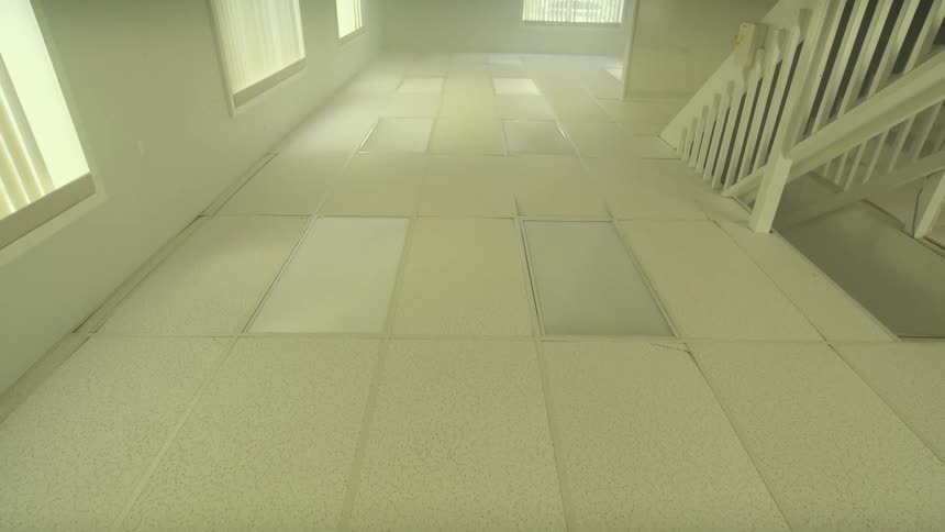 A disorienting camera movement reveals an empty, institutional room that has been built completely upside down