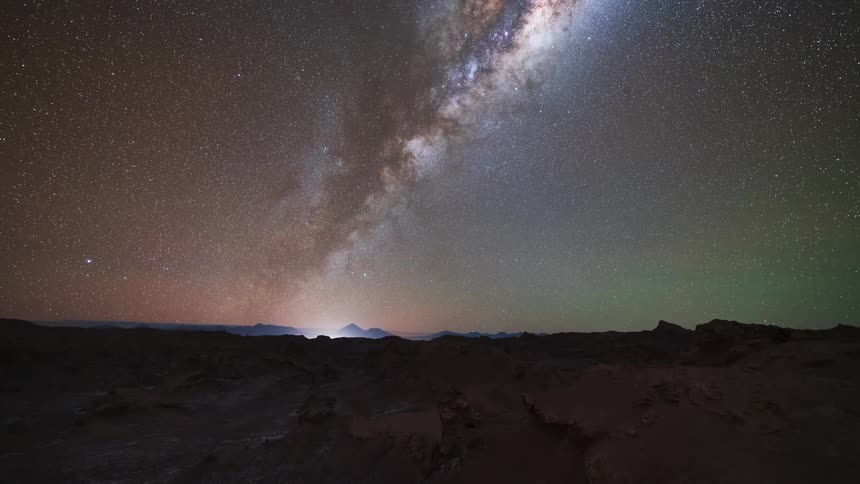 An epic holy grail timelapse captures the full cycle from sunset to a star-filled night sky with the Milky Way, moonrise, and a brilliant sunrise over the Atacama Desert