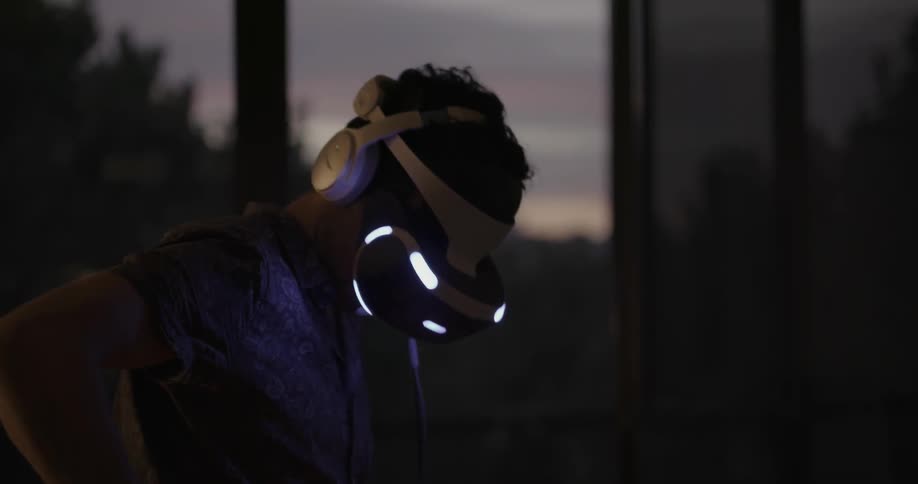 A man is playing virtual reality at dawn