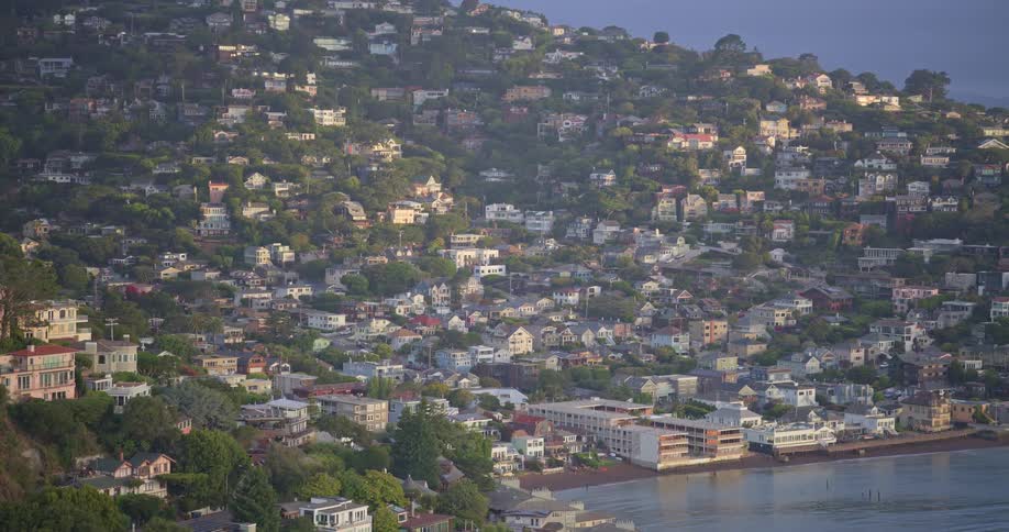A slow zoom shot reveals the beautiful coastal town of Sausalito, California, with houses nestled into the lush green hillside