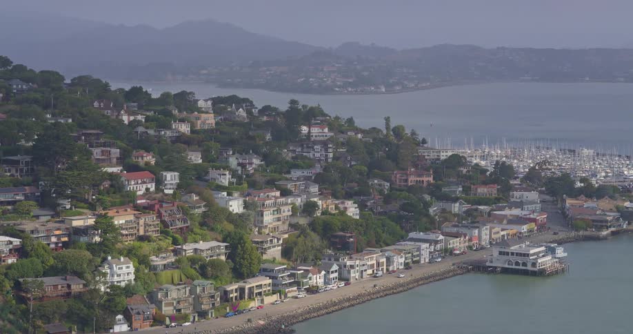 Static high-angle view of the beautiful coastal city of Sausalito, California, with its hillside homes overlooking the marina and bay