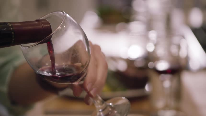Wine is being poured into a glass