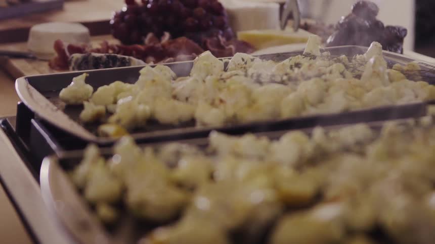 Food steaming on some pans amongst other food