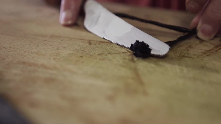 A person cuts a vanilla bean