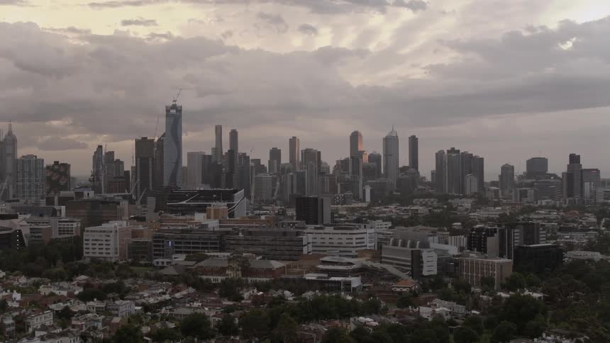 Clouds hover over city skyscrapers