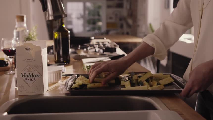 Two people cooking dinner in a kitchen