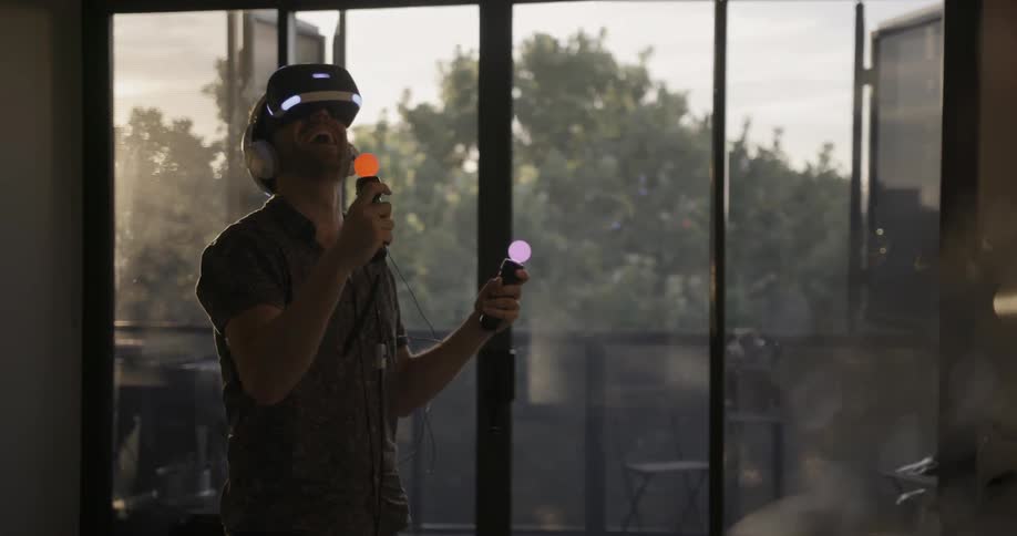 A man is playing a game with a virtual reality headset