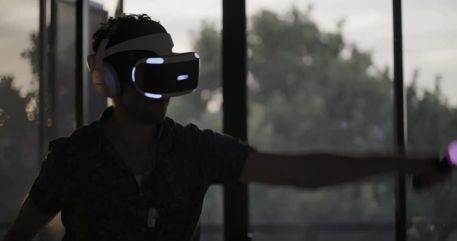 A man is using a vr headset and controllers