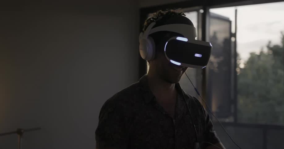 A man smiles while using vr equipment