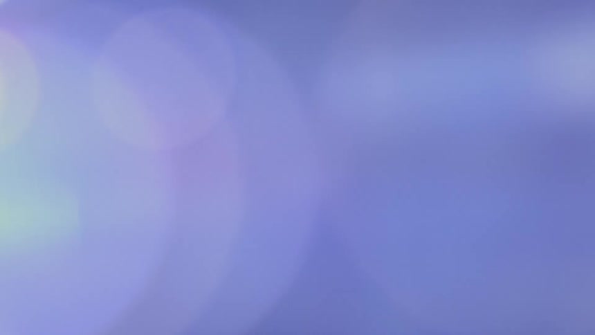 A dreamy, abstract background of shifting cool-toned colors and gentle bokeh lights