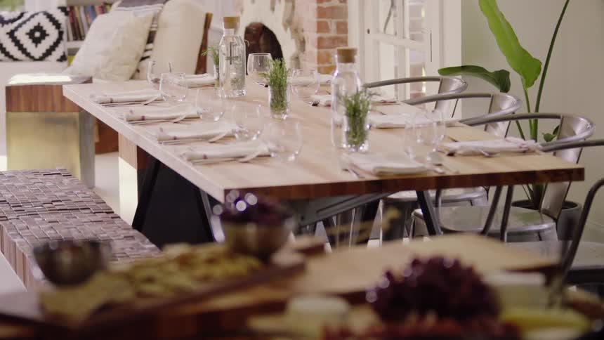 A dinner table sits set and ready for guests