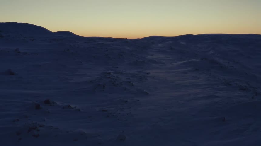 A beautiful timelapse shows the sun rising over the desolate, snow-covered arctic tundra