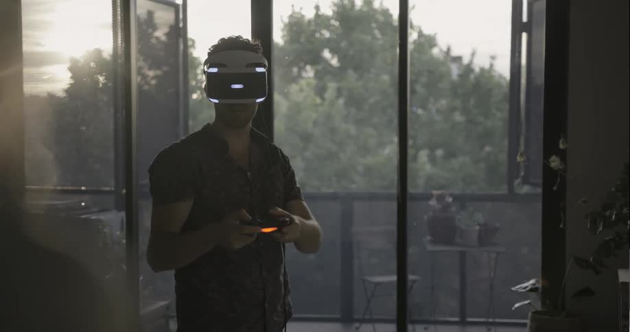A man is using a vr headset and controllers
