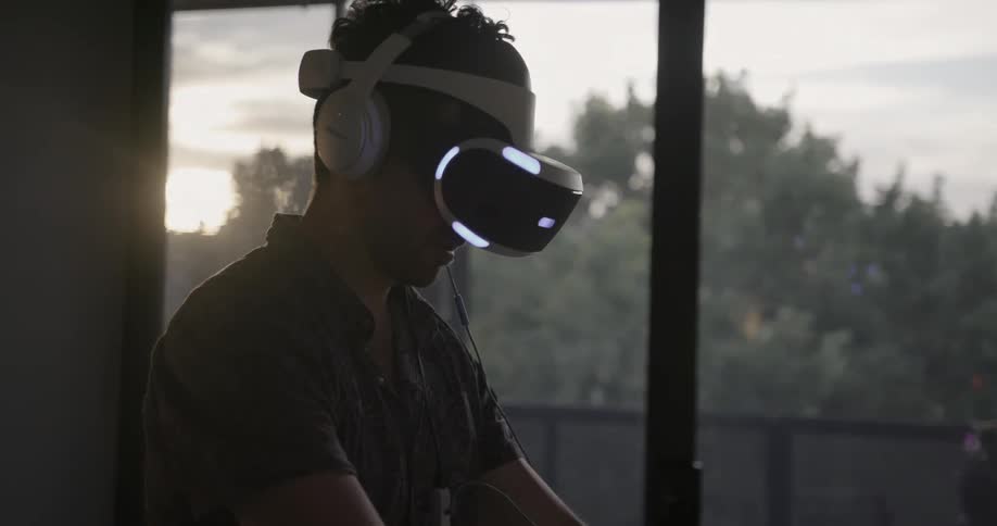 A man is using a vr headset and controllers