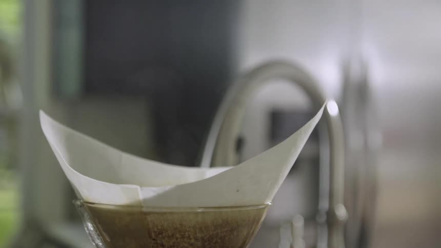 Steam rises from a coffee maker