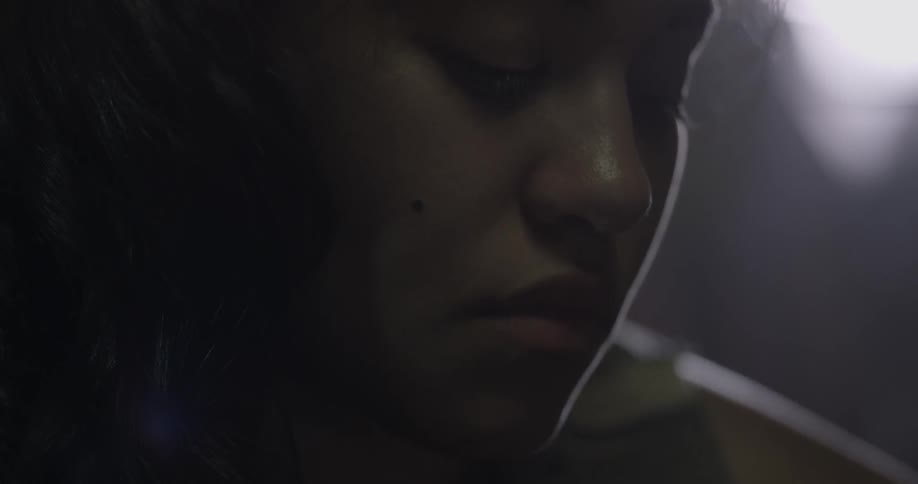 Close-up of a woman's face in a dark area