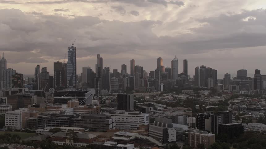 A city sits beneath clouds during the day