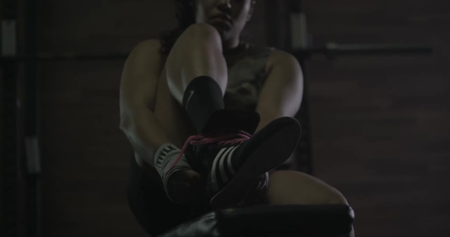 Woman puts shoes on and laces them up