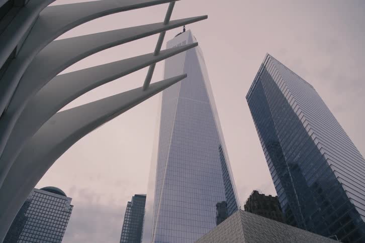 A slow-moving, low-angle shot reveals the impressive architecture of One World Trade Center and the Oculus in New York City