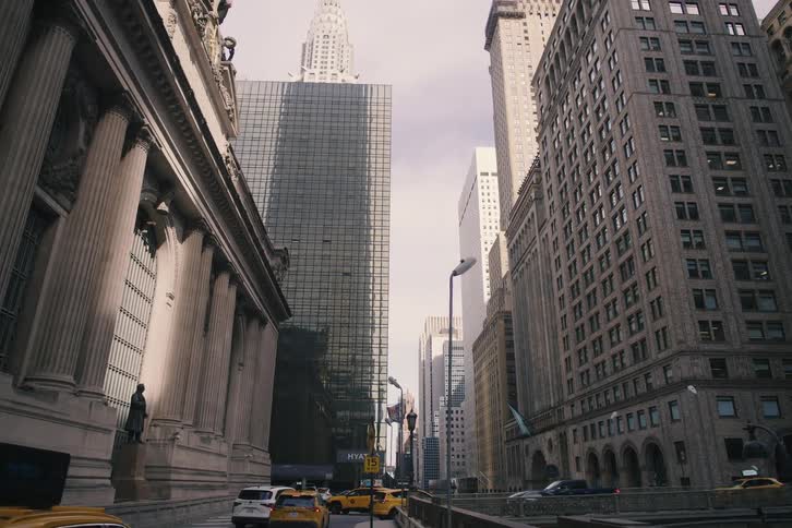 A slow tilt up from a street-level view of Grand Central Terminal reveals the iconic Chrysler Building towering over the New York City skyline