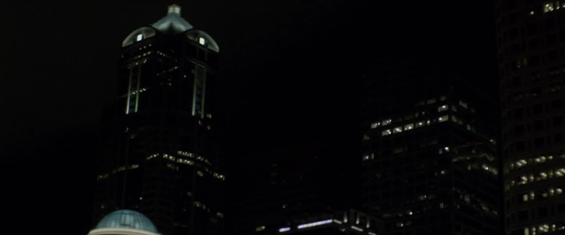 A tall city building towers into the night sky