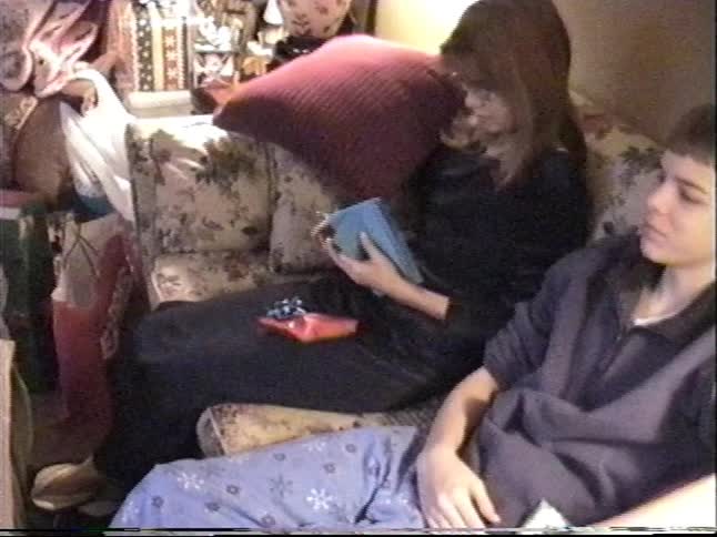 Vintage VHS footage from the 90s shows a girl writing in her new diary on Christmas morning while sitting next to her brother