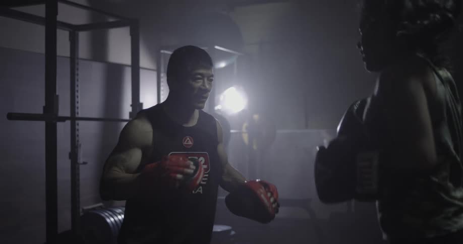A man and woman practice boxing