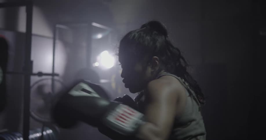 Two people boxing indoors