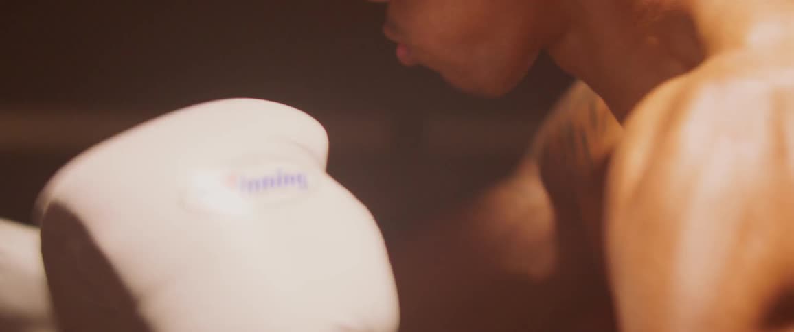 Man wearing boxing gloves punches very fast