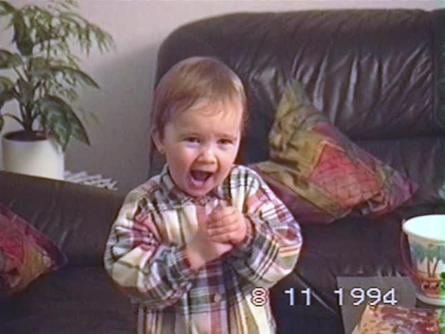 A cute toddler's happy expression quickly turns to tears and crying in a vintage home video from 1994