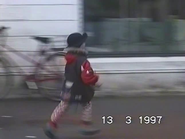 Vintage 1997 home video footage of a young child running happily down a city street