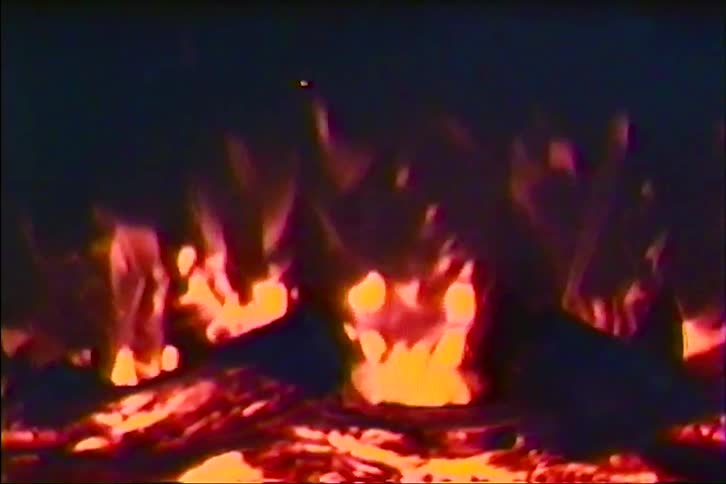 A mesmerizing close-up shot of burning logs and glowing embers in a cozy fireplace