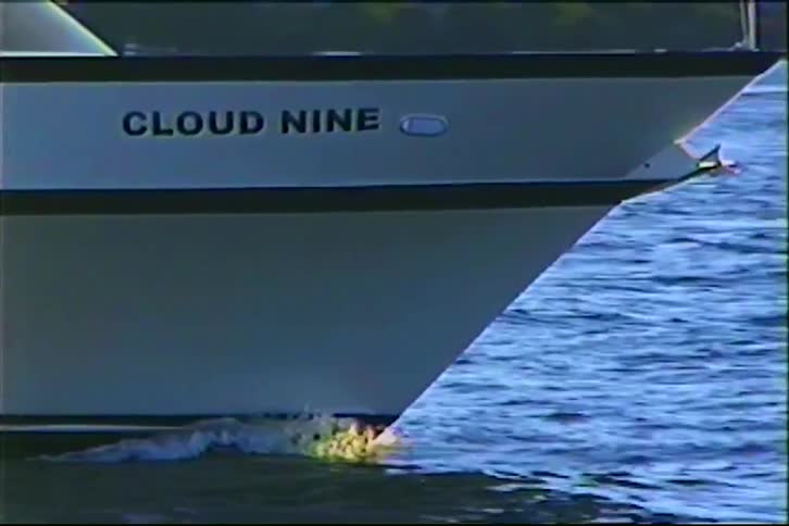 Vintage VHS footage shows a close-up of the bow of the 'Cloud Nine' yacht as it cuts through the water