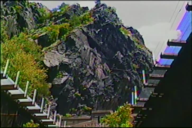 Archival footage captures a low-angle view of the rocky cliffs at Harpers Ferry from underneath a bridge