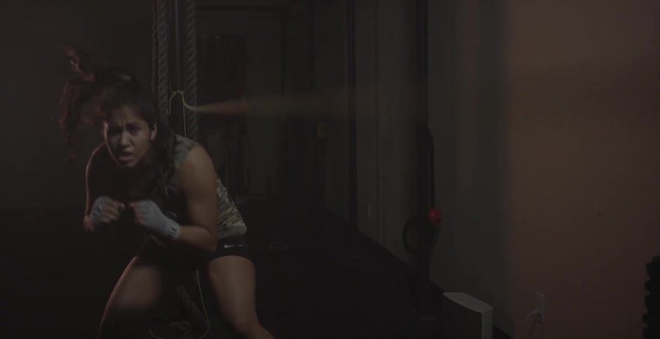 A female fighter is practicing moves